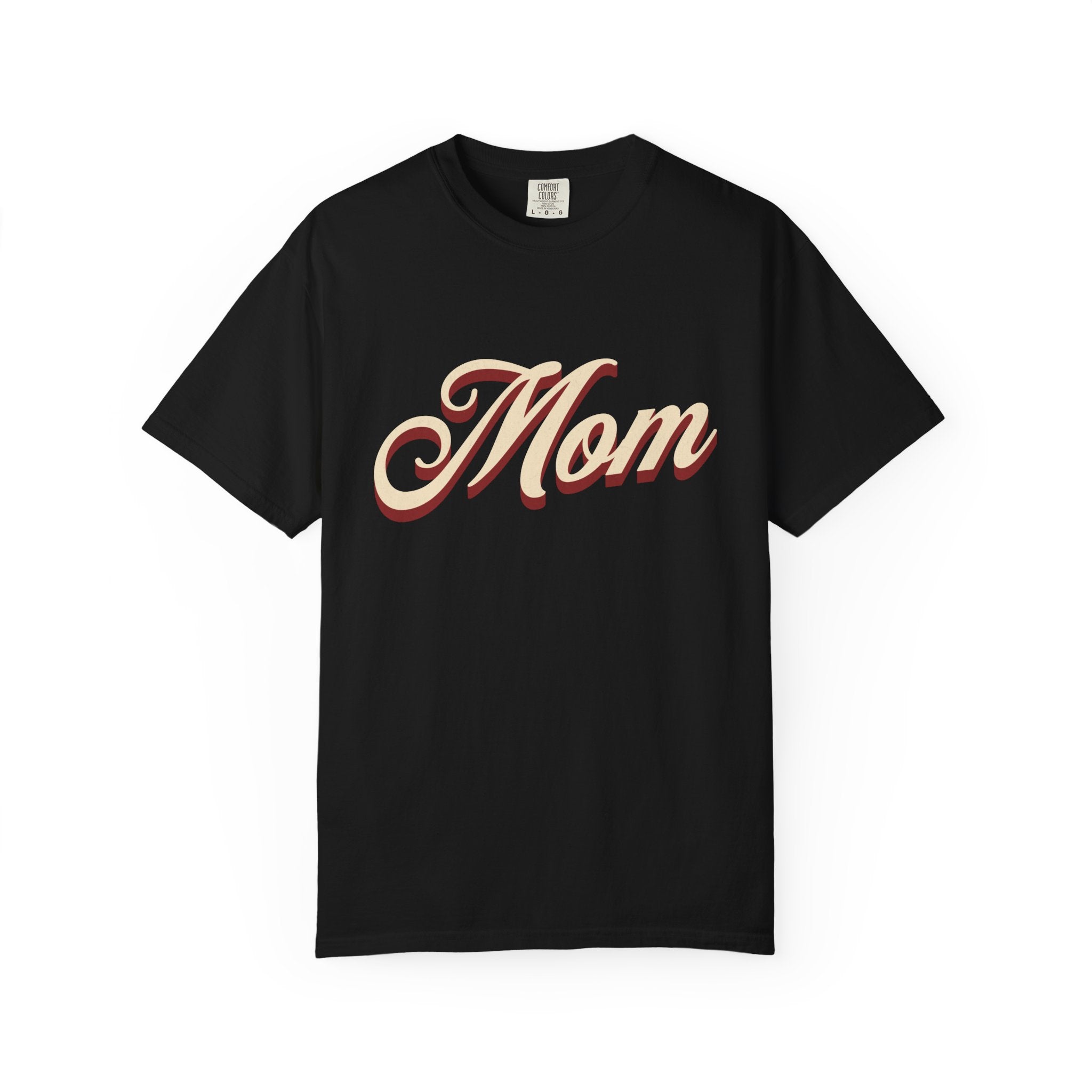 A black short-sleeve crewneck t-shirt featuring the word 'Mom' printed across the chest in a stylized beige cursive font with a red drop shadow, displayed on a clean white background.