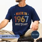Person wearing a navy t-shirt with 'Made in 1967 Built to Last' text, sitting on a light gray background.