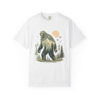 White t-shirt with a graphic of a bigfoot-like creature in a forest design on a white background