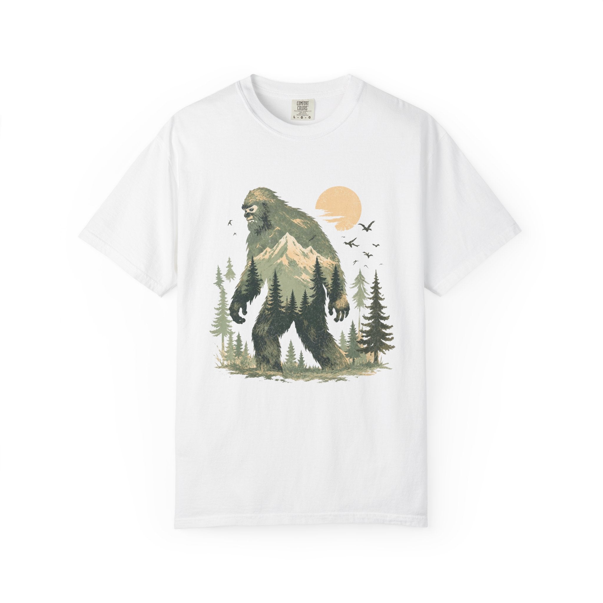 White t-shirt with a graphic of a bigfoot-like creature in a forest design on a white background