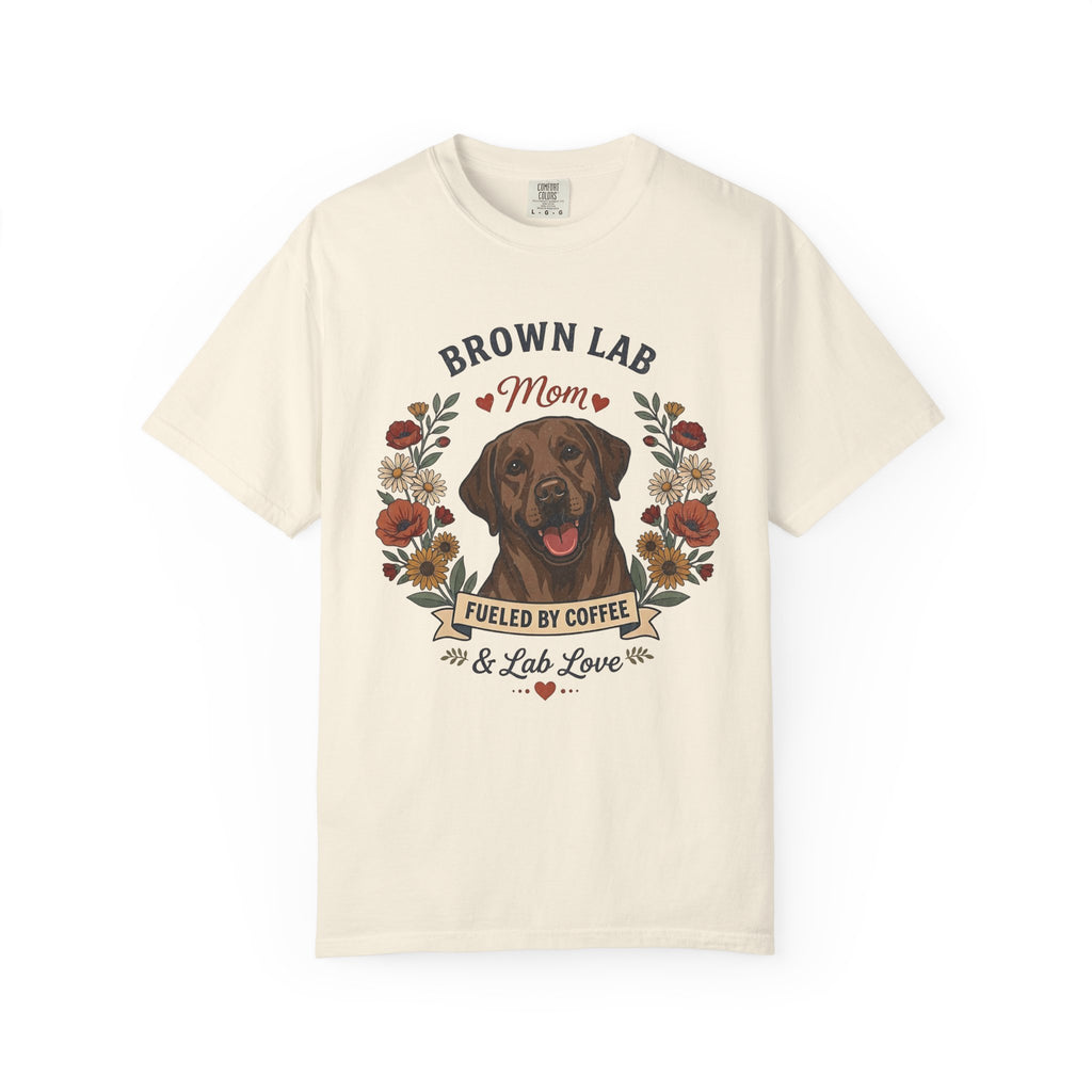 An off-white short-sleeve crewneck t-shirt featuring a graphic print of a brown Labrador Retriever with the text 'BROWN LAB Mom' and 'FUELED BY COFFEE & Lab Love' surrounded by a floral wreath.