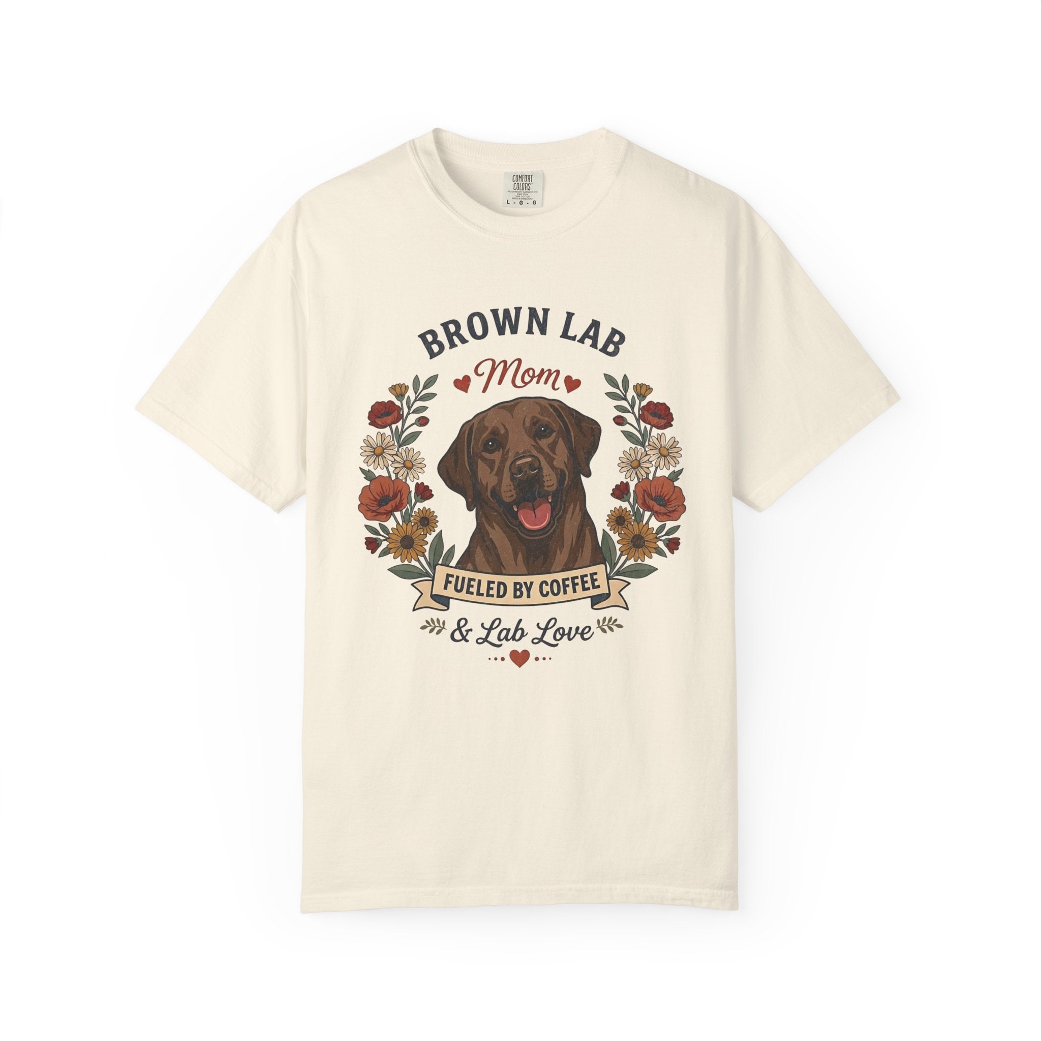 An off-white short-sleeve crewneck t-shirt featuring a graphic print of a brown Labrador Retriever with the text 'BROWN LAB Mom' and 'FUELED BY COFFEE & Lab Love' surrounded by a floral wreath.