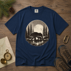 Navy blue t-shirt with bear and forest design on a wooden surface with nature-themed items.